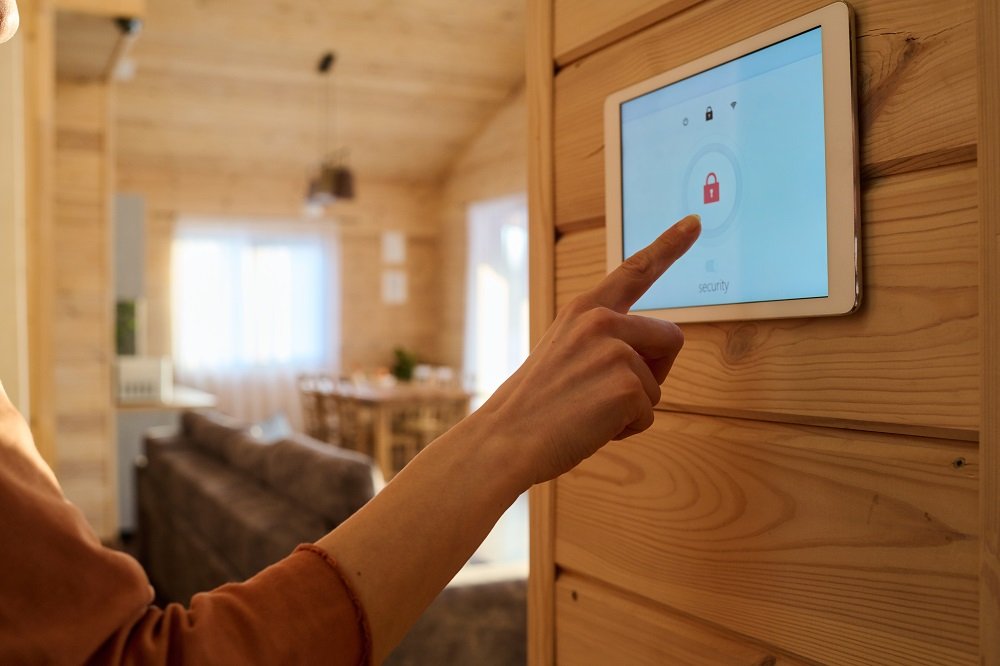 Hand of young woman or housewife pointing at screen with lock sign